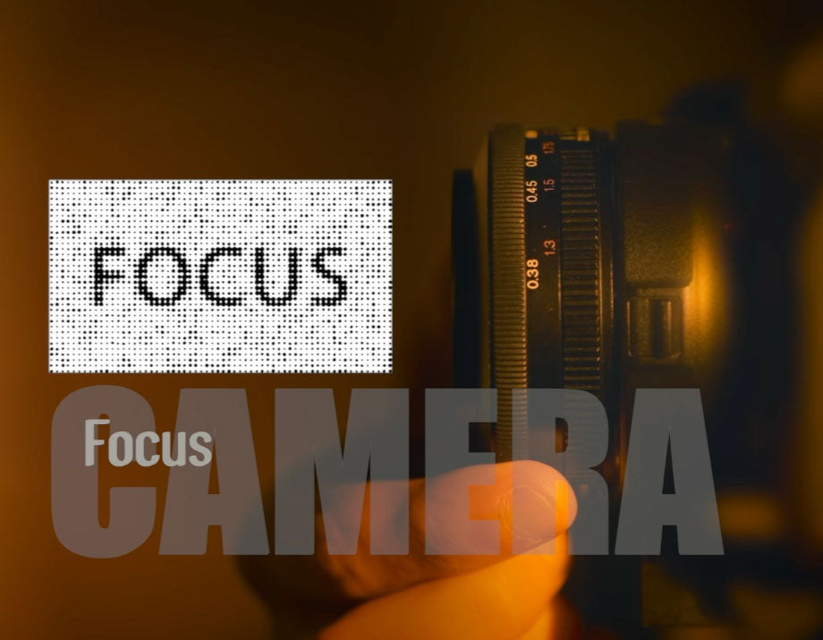 Camera lens with 'FOCUS' text overlay on a dark background