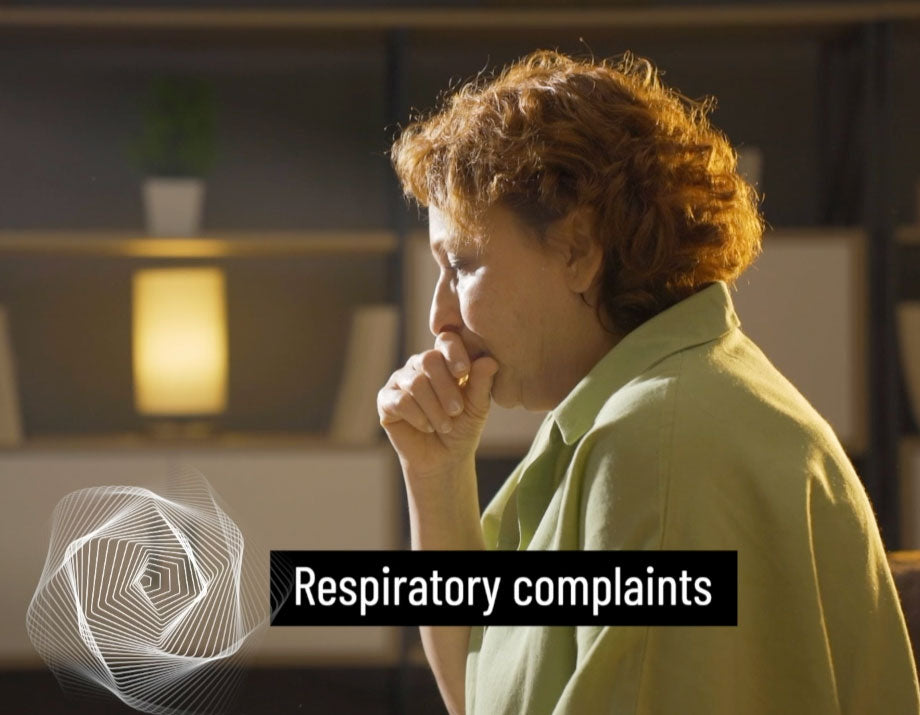 Woman with respiratory complaints in a room with a blurred background