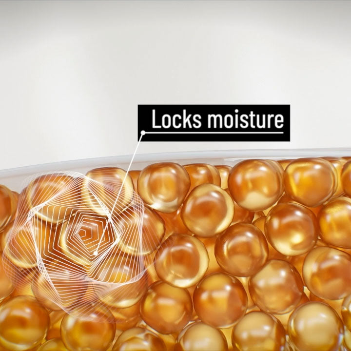 Close-up of amber-colored gel beads with a label indicating 'Locks moisture' on a light gray background.