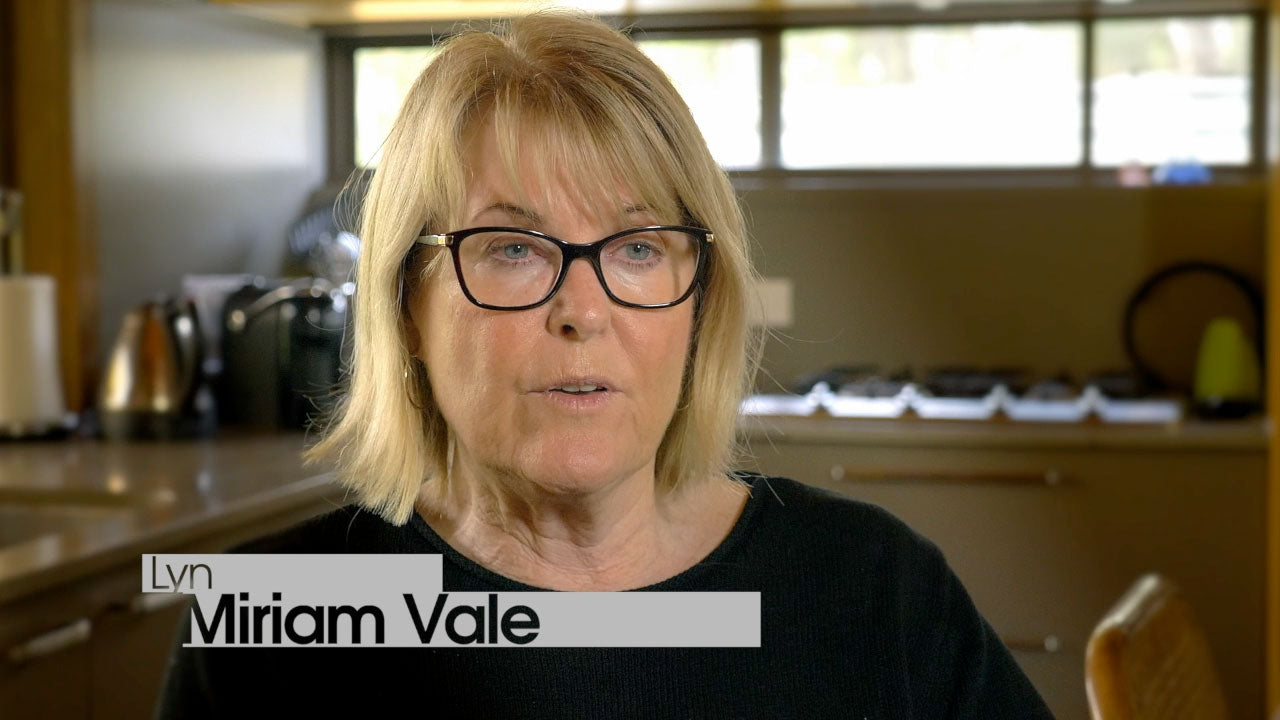 Woman with glasses in a kitchen setting, with 'Lyn Miriam Vale' text overlay